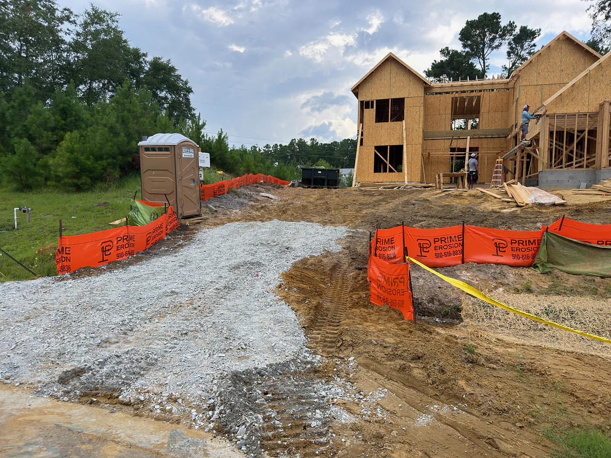 Silt fence protecting an active homebuilding lot with framing underway