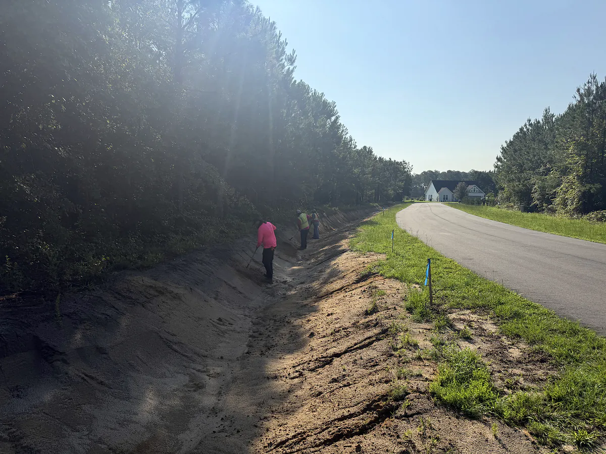 construction crew regrading a roadside swale in a neighborhood in wilmington nc